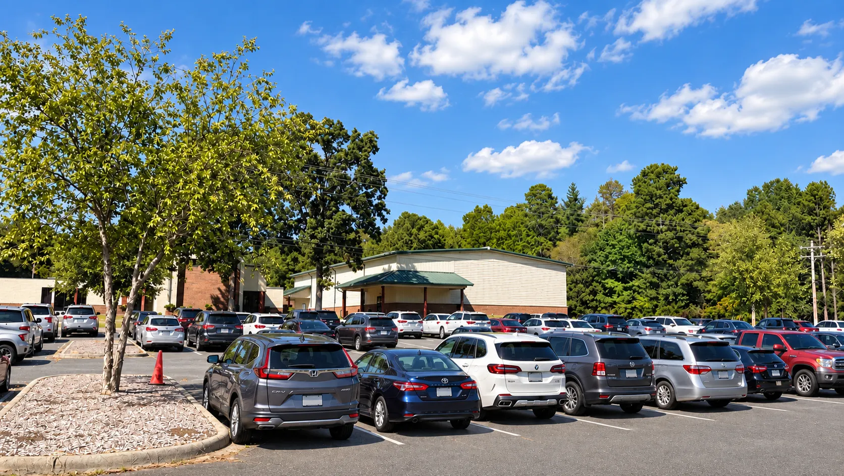 Sunlit view of the Next Level Church buildings and parking lot in Matthews, NC